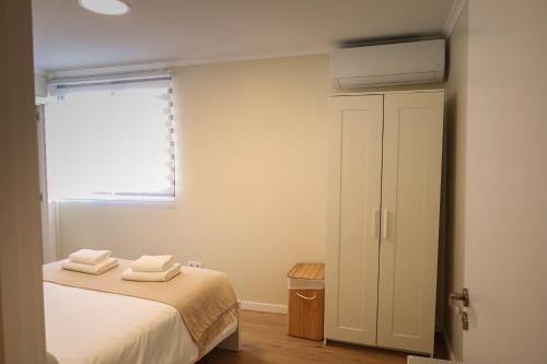 a bedroom with a bed with two towels on it at Brooklyn&Fennel House in Funchal