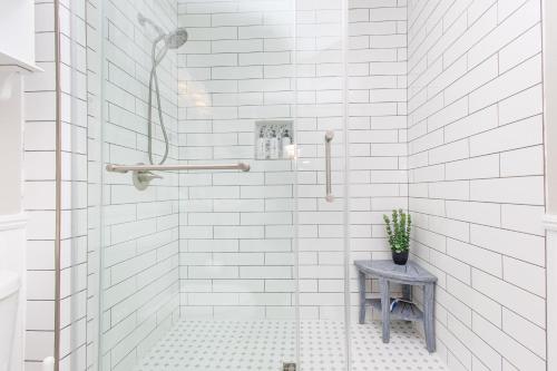 a bathroom with white subway tile and a shower at Baywatch D11 in Pensacola Beach