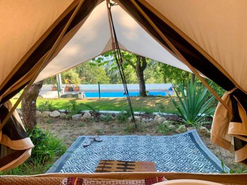 a view from inside a tent with a pool at Glamping de Cerveira in Vila Nova de Cerveira