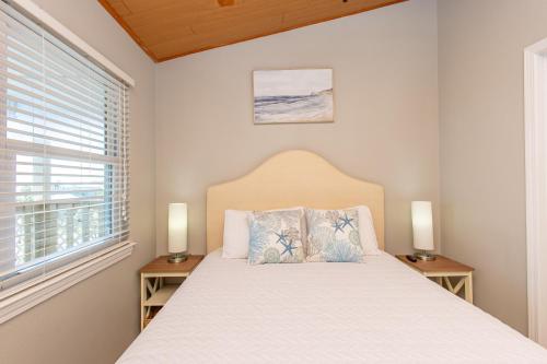 a bedroom with a bed with two night stands at Baywatch D11 in Pensacola Beach
