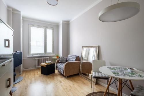 a living room with a couch and a table at Bright 1BR apartment in Kallio with best location in Helsinki