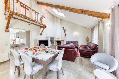 un salon avec une table et des chaises dans l'établissement Maison Évasion Panoramique entre Paris et Disney, à Noisy-le-Sec
