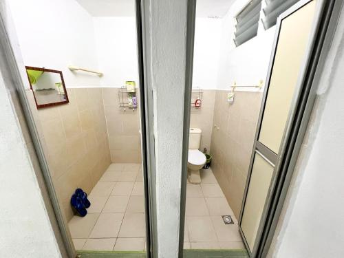 a bathroom with a shower and a toilet at Sehijau Homestay Taman Ira in Kangar