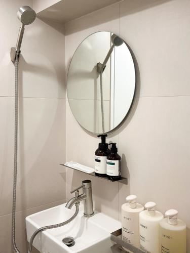 a bathroom with a sink and a mirror on the wall at Gurida Bupyeong in Incheon