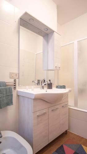 a bathroom with a sink and a toilet and a mirror at Venezia 1851 in Venice