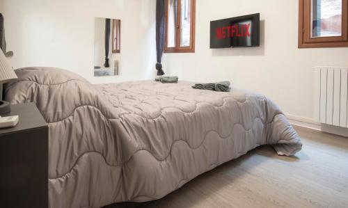 a bed with a comforter on it in a room at Venezia 1851 in Venice