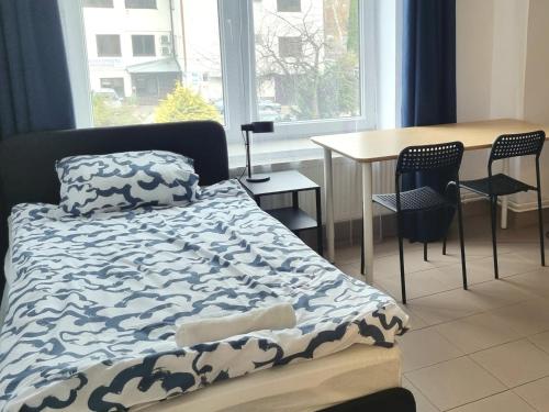 a bedroom with a bed and a table and chairs at Pokoje przy szpitalu - Lwowska in Rzeszów