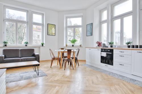 a kitchen and dining room with a table and chairs at Apartament na Granicy 6 in Cieszyn