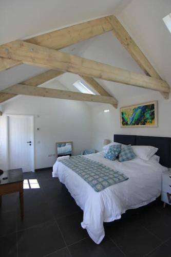 a bedroom with a large white bed in a room at The Lambing Shed, Converted Barn nr Little Haven in Haverfordwest