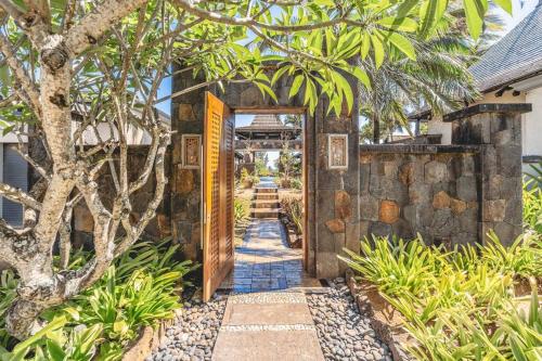 an entrance to a house with a stone wall at Villa Sea View by IHR in Bel Ombre