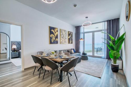 a dining room and living room with a table and chairs at GlobalStay Royal Bay Beachfront Apartments Palm Jumeirah in Dubai