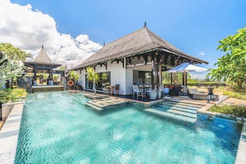 a swimming pool in front of a villa at Villa Sea View by IHR in Bel Ombre