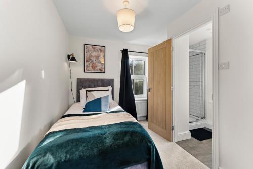 a bedroom with a bed and a window at Amazing Rural Retreat in The Cotswolds - Parking in Frome
