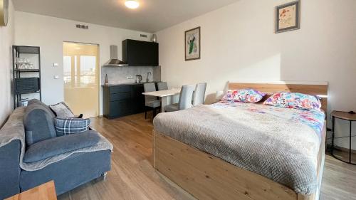 a bedroom with a bed and a couch and a table at Matilda108 in Prague