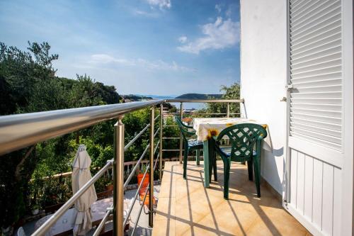 a balcony with a table and chairs on it at Apartments Marija in Supetarska Draga