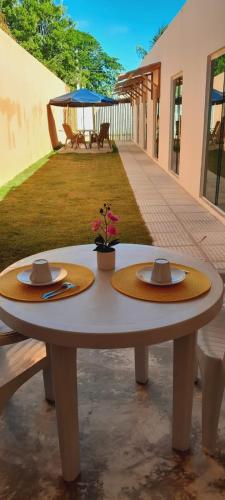 a table with two straw hats on top of it at Pousada Flor da Barra in Maragogi