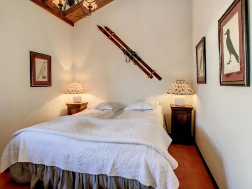 a bedroom with a white bed and two lamps at Lichen 8 in Verbier