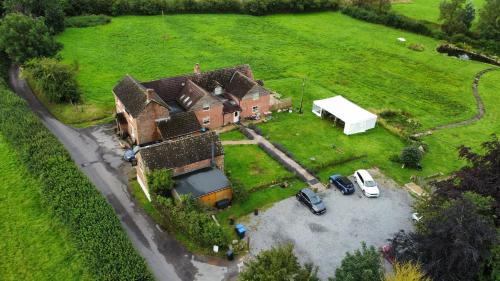 an aerial view of a house with cars parked in a parking lot at Elderbrook House in Avebury