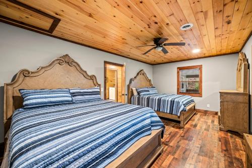 a bedroom with two beds and a wooden ceiling at Twin Oak Creek in Gatlinburg