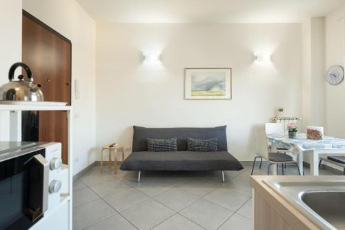 a living room with a couch in a kitchen at Crystal house FRONT TRAMVIA in Florence