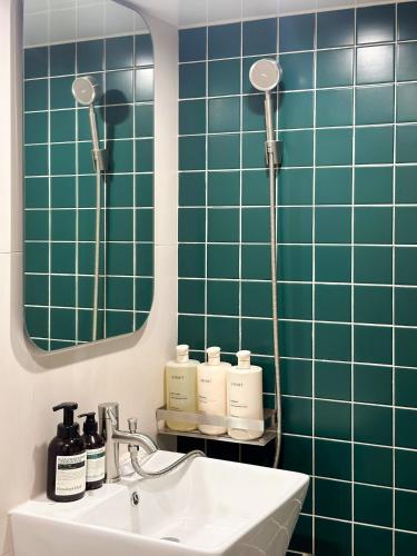 a bathroom with a sink and a mirror at Gurida Bupyeong in Incheon