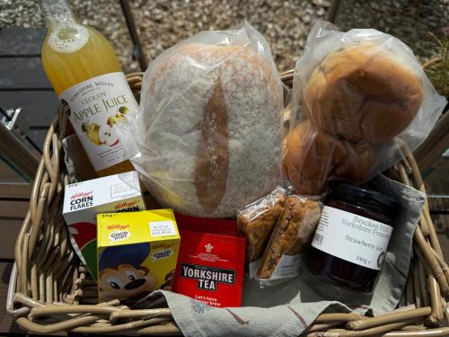a basket filled with bread and other food items at Hundle Dale- Bugthorpe Grange Glamping in Stamford Bridge