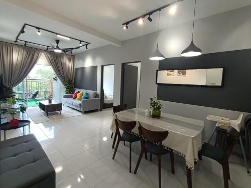 a kitchen and living room with a table and chairs at Dream 6 Emerald avenue in Cameron Highlands