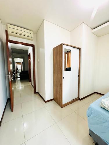 a room with a bed and a door in it at Emaar Moslem Friendly Stunning Comfy 2BR Apartment at the heart of Jakarta in Jakarta