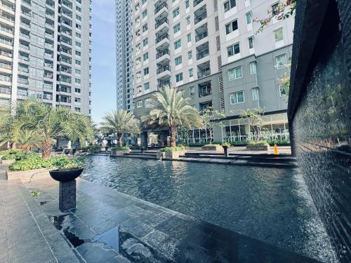 a river in the middle of a city with tall buildings at Emaar Moslem Friendly Stunning Comfy 2BR Apartment at the heart of Jakarta in Jakarta
