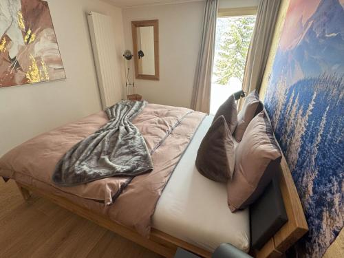 a bedroom with a bed and a window at Casa Ladina 2 in Falera