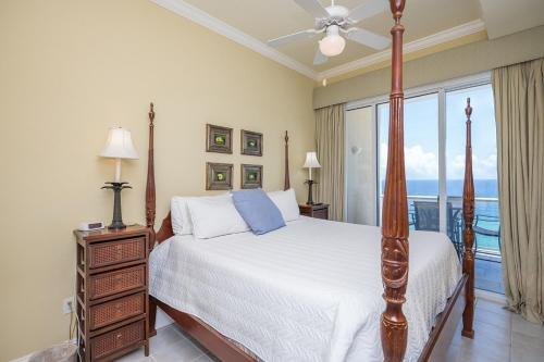 a bedroom with a bed and a large window at Emerald Isle Gulf Front 2B Condo - 1706 in Pensacola Beach