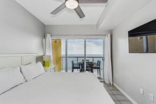 a bedroom with a bed and a view of the ocean at Emerald Isle Gulf Front 2B Condo - 1604 in Pensacola Beach