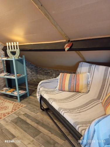 a bed in a room with a table and a chair at O Mundo da Lua in Azeitao