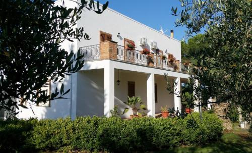 a white house with a balcony on top of it at Il Delfino in Pisticci