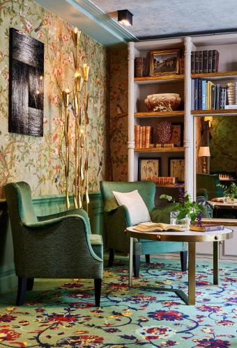 a living room with two chairs and a table at Maison Boissière BARNES Residences in Paris