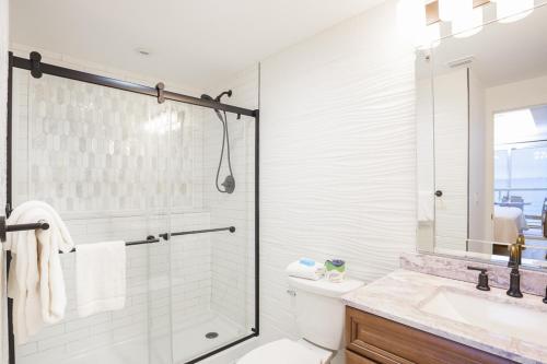 a bathroom with a shower and a toilet and a sink at Emerald Isle Gulf Front 2B Condo - 805 in Pensacola Beach