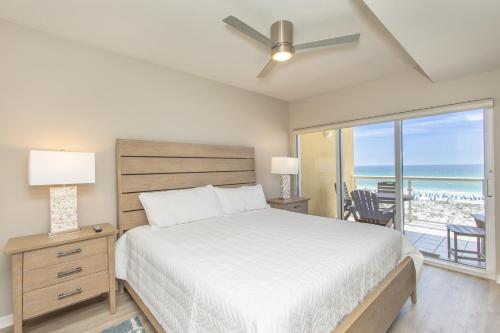 a bedroom with a bed and a view of the ocean at Emerald Isle Gulf Front 3B Condo - 308 in Pensacola Beach
