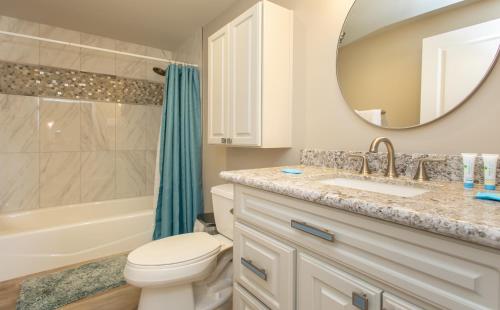 a bathroom with a sink toilet and a mirror at Emerald Isle Gulf Front 3B Condo - 308 in Pensacola Beach
