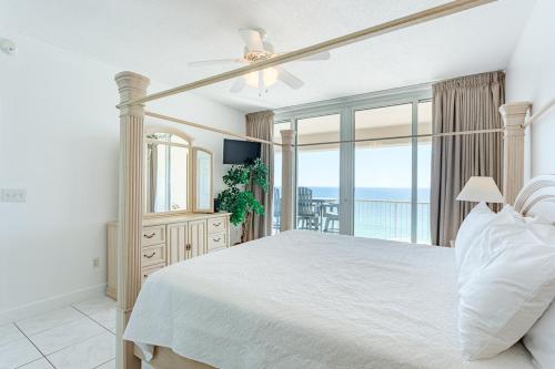 a bedroom with a bed and a view of the ocean at Regency Towers Gulf Front 3B Condo in Navarre