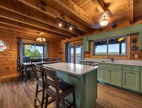 a kitchen with a large island in a log cabin at BEST VIEWS LAKE FRONT Waters Edge in Dandridge