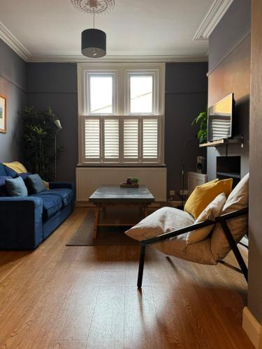 a living room with a couch and a table at Townhouse in trendy suburb of Hoole in Chester