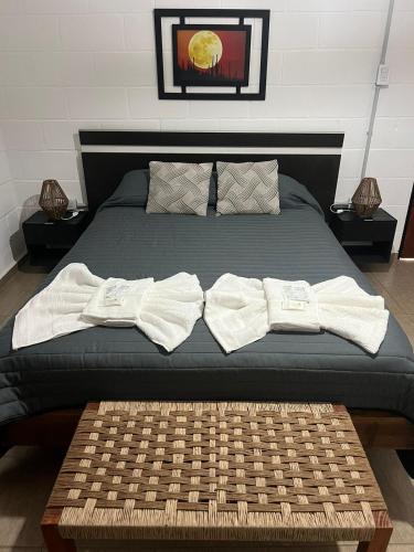 a bed with two white towels on top of it at Tres Soles in Salsipuedes
