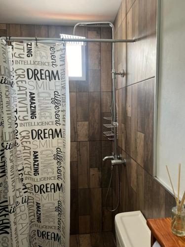 a bathroom with a shower with a shower curtain at Tres Soles in Salsipuedes