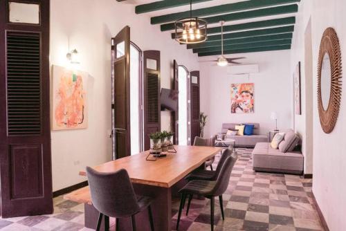 a living room with a wooden table and chairs at Old San Juan Rentals in San Juan