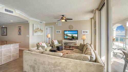 a living room with a couch and a tv at Beach Club Gulf Front 3B Condo - 1204 in Pensacola Beach