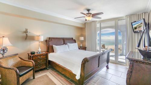 a bedroom with a bed and a balcony at Beach Club Gulf Front 3B Condo - 1204 in Pensacola Beach