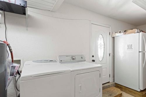 a kitchen with a white stove and a refrigerator at Sea Breeze - 5B Beach Home in Pensacola Beach