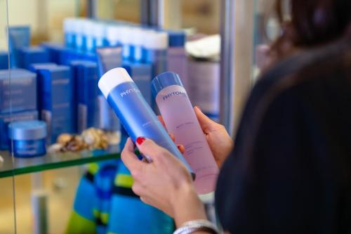 a woman is holding a hair dryer in a store at Beach Club Gulf Front 3B Condo - 2003 in Pensacola Beach