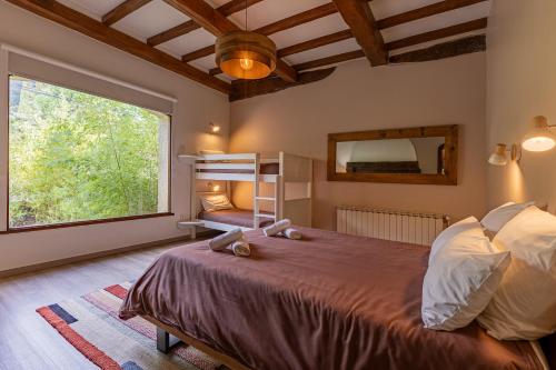 a bedroom with a large bed and a large window at L'Interlude in Mons