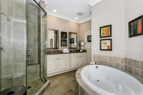 a large bathroom with a tub and a shower at Beach Club Gulf Front 3B Condo - 2004 in Pensacola Beach